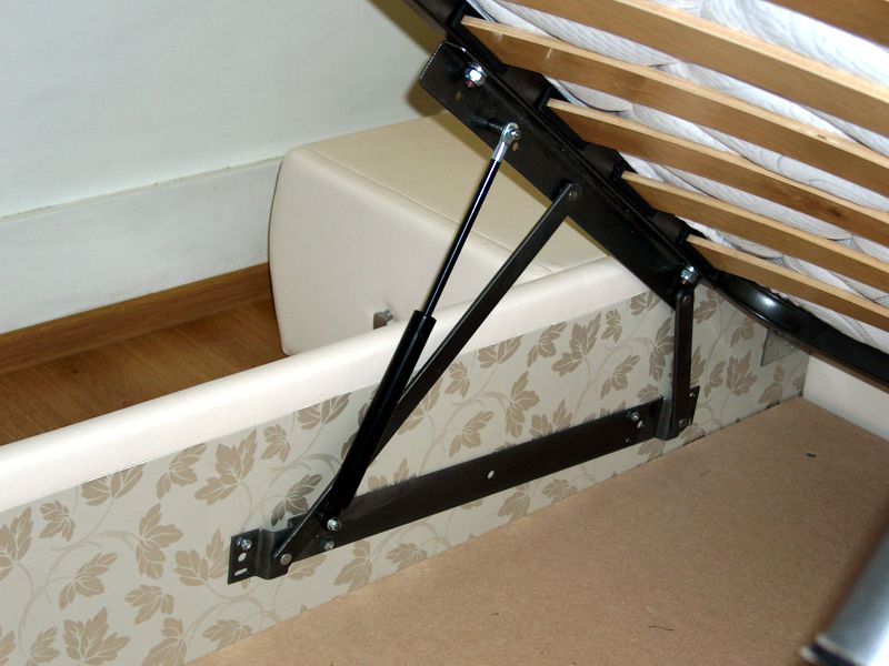 Système de ressort pour soulever le cadre des meubles d'armoire